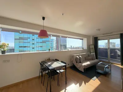 a living room with a couch and a tv at Sotell Apartment Gran Via Europa BCN in Las Corts