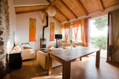 a living room with a table and a couch at Cal Pau Cruset in Torrellas de Foix
