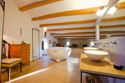 a bathroom with two sinks and a bath tub at Cal Pau Cruset in Torrellas de Foix