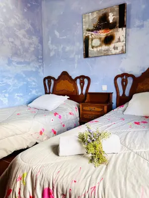a bedroom with two beds with flowers on them at Masia Pau Prat in Lliçà d'Amunt