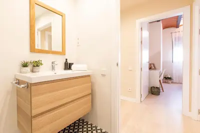 a bathroom with a sink and a mirror at Barcelona Touch Apartments - Campalans in Hospitalet de Llobregat