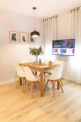 a dining room with a wooden table and chairs at Barcelona Touch Apartments - Campalans in Hospitalet de Llobregat