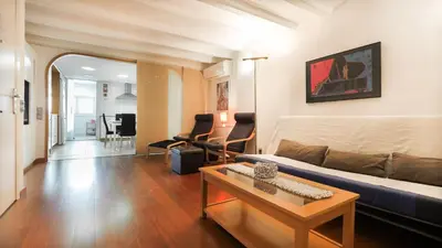 a living room with a couch and a table at Bed&BCN Gracia III in Barcelona
