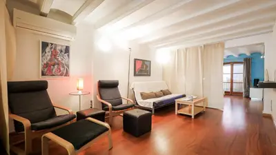 a living room with two chairs and a couch at Bed&BCN Gracia III in Barcelona