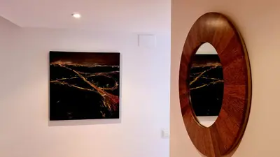 a wooden mirror on a wall next to a painting at Forum-CCIB-Relax Flats in Sant Adria de Besos