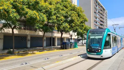 a blue and white tram on a city street at Forum-CCIB-Relax Flats in Sant Adria de Besos