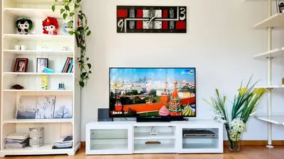 a living room with a flat screen tv on a white entertainment center at Forum-CCIB-Relax Flats in Sant Adria de Besos
