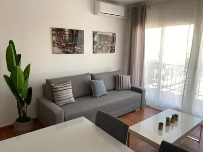 a living room with a couch and a table at Vilamarlux V in Vilassar de Mar