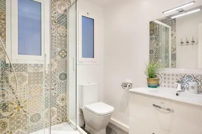 a white bathroom with a toilet and a shower at Stay U-nique Apartments Mallorca in Barcelona