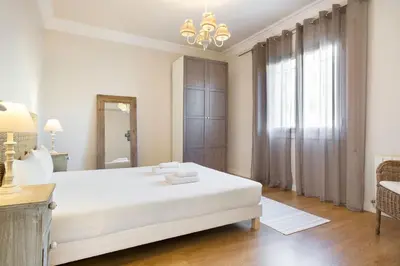 a white bedroom with a large bed and a window at Stay U-nique Apartments Mallorca in Barcelona