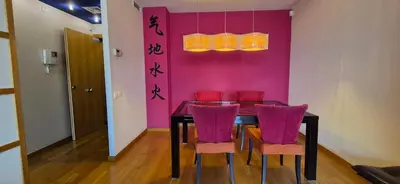 a living room with a glass table and red chairs at Avenida Diagonal distrito tecnológico 22 arroba - Angeles Terraza in Barcelona