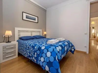 a bedroom with a blue and white bed with blue pillows at Apartment Sagrada Familia Grassot - Industria by Interhome in Barcelona