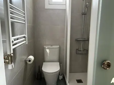 a small bathroom with a toilet and a shower at Apartment Sagrada Familia Grassot - Industria by Interhome in Barcelona