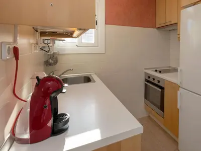 a kitchen with a red mixer on a counter at Apartment Sagrada Familia Grassot - Industria by Interhome in Barcelona