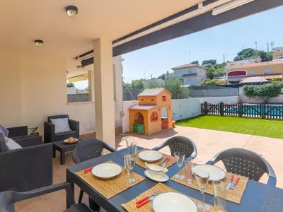 a blue table with plates and glasses on a patio at Holiday Home Nova by Interhome in Segur de Calafell