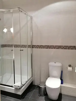 a bathroom with a shower and a white toilet at Ghat Apartment Poble Sec Barcelona in Barcelona
