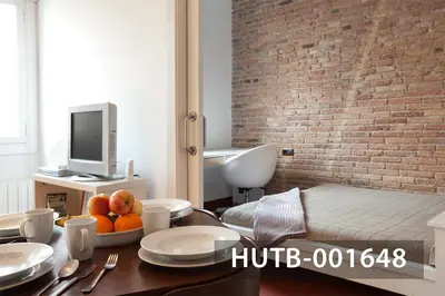 a room with a table with plates and fruit on it at Ghat Apartment Poble Sec Barcelona in Barcelona