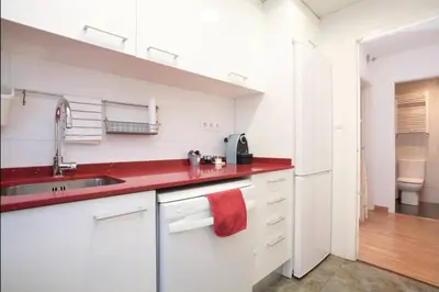 a kitchen with a sink and a red counter top at Apartamento Parc Güell in Barcelona