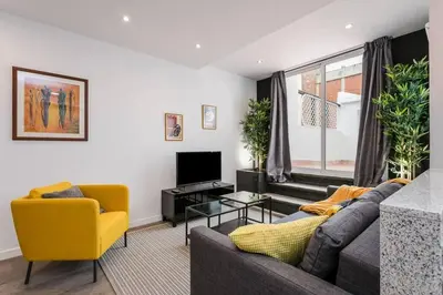 a living room with a couch and a yellow chair at 3 Bdr&terrace Close To Subway in Hospitalet de Llobregat