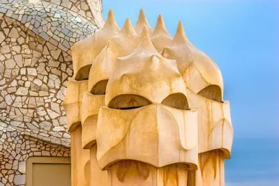 a wooden mask on the side of a building at MUNTANYA - Apartments & one with Terrace next to Sagrada Familia in Barcelona