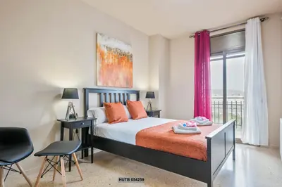 a bedroom with a bed and a large window at Alcam Sant Adria in Sant Adria de Besos