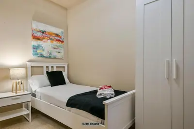 a small bedroom with a bed and a closet at Alcam Sant Adria in Sant Adria de Besos