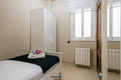 a bedroom with a white bed with a towel on it at Alcam Sant Adria in Sant Adria de Besos