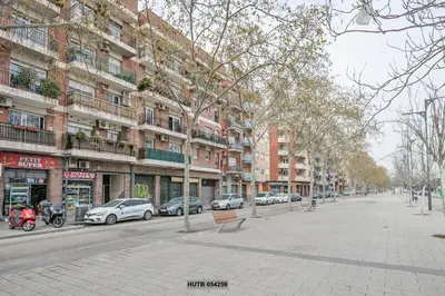 a city street with cars parked in front of buildings at Alcam Sant Adria in Sant Adria de Besos