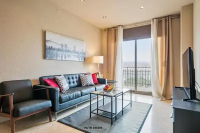 a living room with a couch and a television at Alcam Sant Adria in Sant Adria de Besos