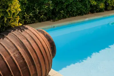 a wooden barrel sitting next to a swimming pool at CIM Apartments in Olivella