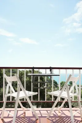 a white table and two chairs on a balcony at Loft Ponent, Sant Pol de Mar in San Pol de Mar