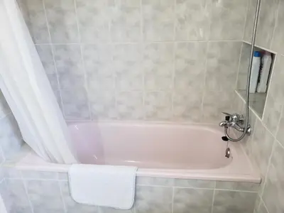 a bathroom with a bath tub with a shower at Apart.3 habit.mar-mont. AC-Terraza-ascensor-parking in Calella