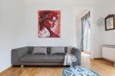 a living room with a couch and a painting on the wall at Art House Station Rocafort ´Sant Antoni´ in Barcelona