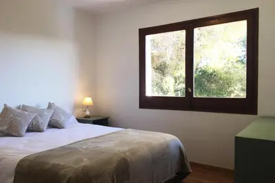a bedroom with a large bed with a window at TERRAVU in Sant Pere de Ribes