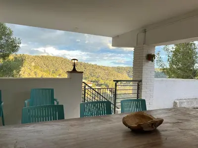 a table and chairs with a view of a mountain at TERRAVU in Sant Pere de Ribes
