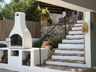 a set of stairs with a pizza oven in a yard at TERRAVU in Sant Pere de Ribes