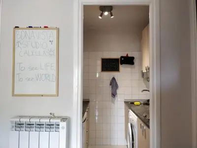 a kitchen with a sink and a white tiled wall at Bonavista Bright Sea View Studio with Balcony in Calella