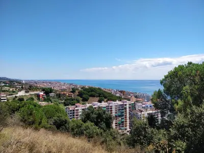 a view of a city with the ocean in the background at Bonavista Bright Sea View Studio with Balcony in Calella