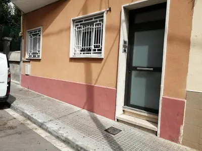 a building with two windows and a door at Ahllenrock Cornellà - Parking Gratis- Cerca BCN in Cornellà de Llobregat