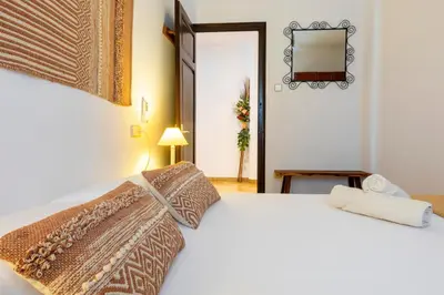 a bedroom with a white bed and a mirror at 8 to 10 Sleeps Private Pool Villa & BBQ Near Barcelona in Rocafort