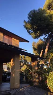 a building with a tree in front of it at Casa Feliz in Sant Cebrià de Vallalta