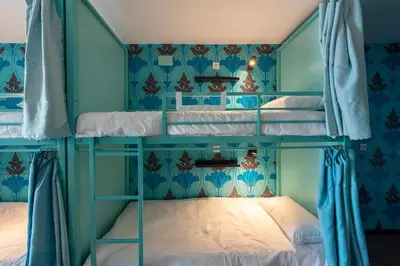 two bunk beds in a room with blue walls at Hostelle - Women only hostel Barcelona in Barcelona