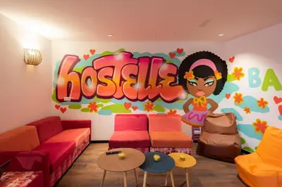 a room with a wall with a disney sign at Hostelle - Women only hostel Barcelona in Barcelona
