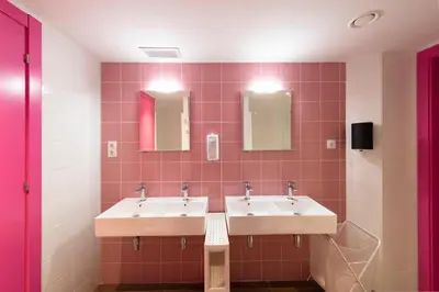 a bathroom with two sinks and two mirrors at Hostelle - Women only hostel Barcelona in Barcelona