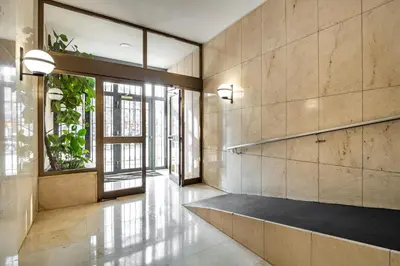 a hallway with a bench in a room with windows at Stay U-nique Apartments Marina in Barcelona