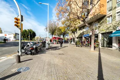 a street with motorcycles parked on the side of the road at Stay U-nique Apartments Marina in Barcelona