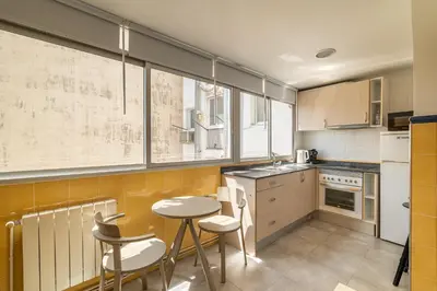 a kitchen with a table and some chairs in it at Stay U-nique Apartments Aribau in Barcelona