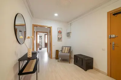 a room with a mirror and a chair and a table at Stay U-nique Apartments Aribau in Barcelona