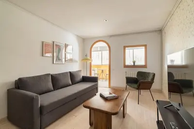 a living room with a couch and a table at Stay U-nique Apartments Aribau in Barcelona