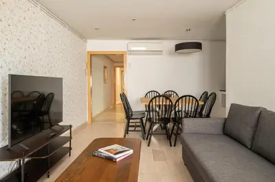 a living room with a couch and a table and chairs at Stay U-nique Apartments Aribau in Barcelona